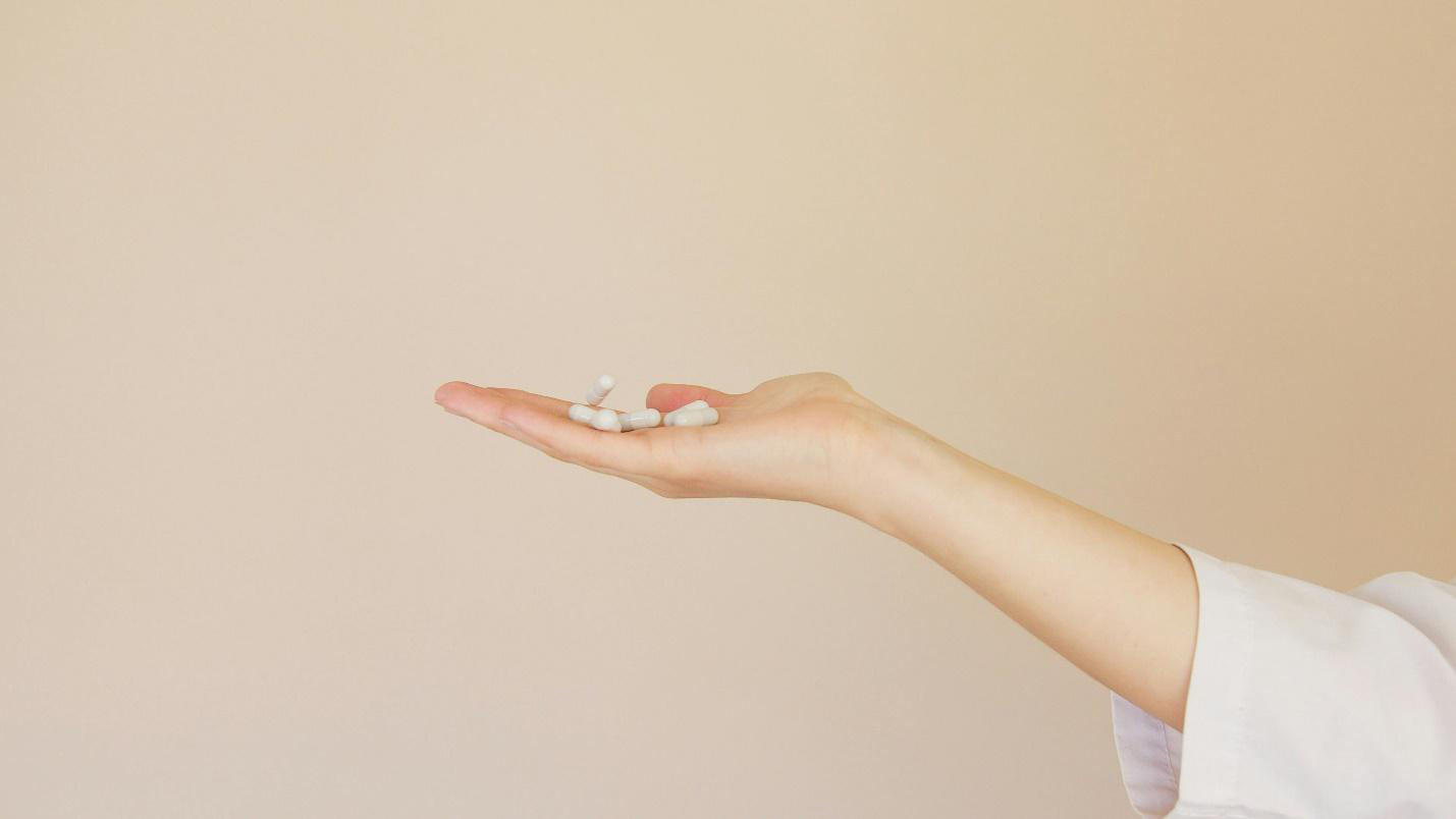  A picture of a hand of a person holding pills
