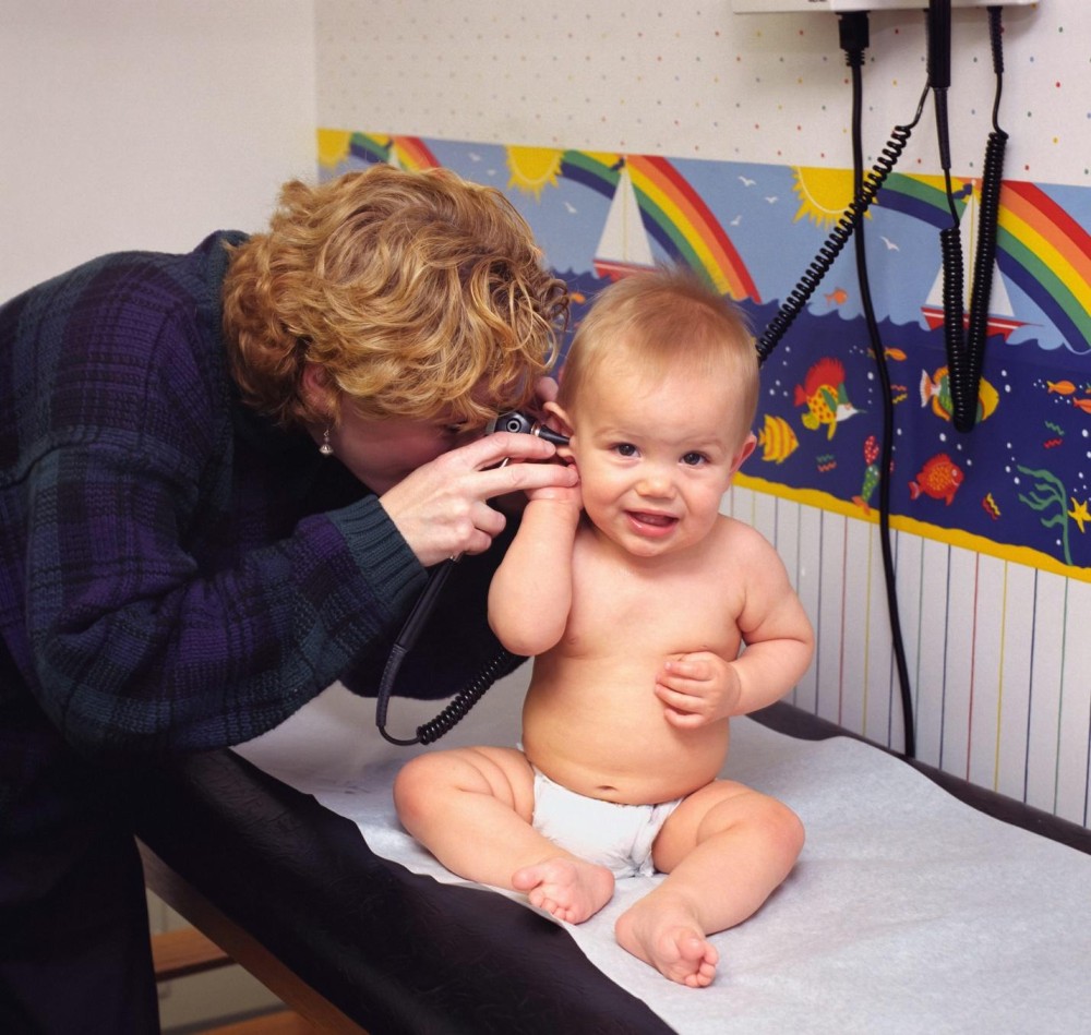 A doctor checking a toddler