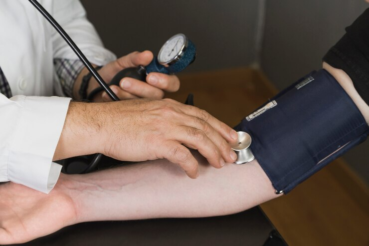 Doctor checking the blood pressure of a patient