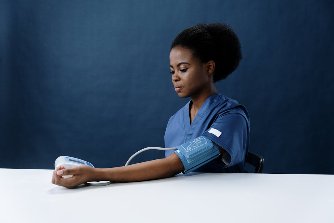 A woman working with a blood pressure meter. 